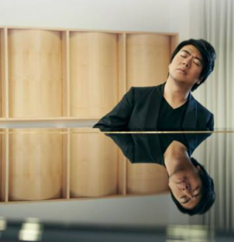 Portrait of pianist Lang Lang with his body reflected in the piano lid.